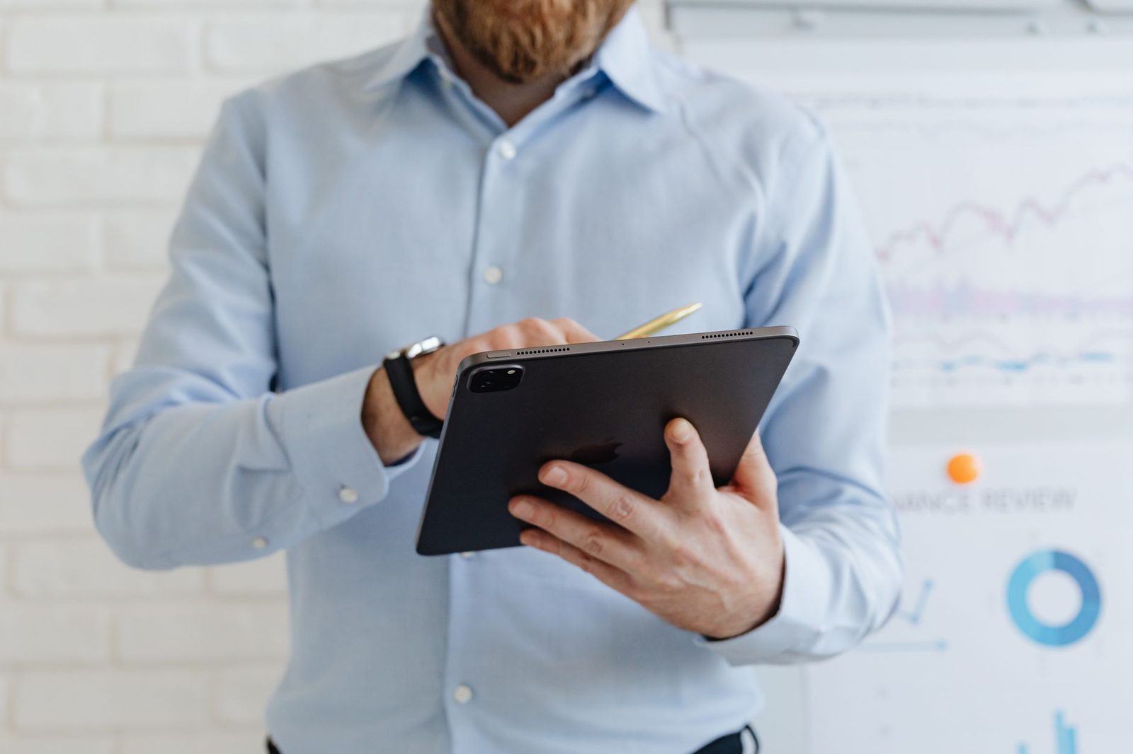 Businessman reviewing automated workflow data on a tablet