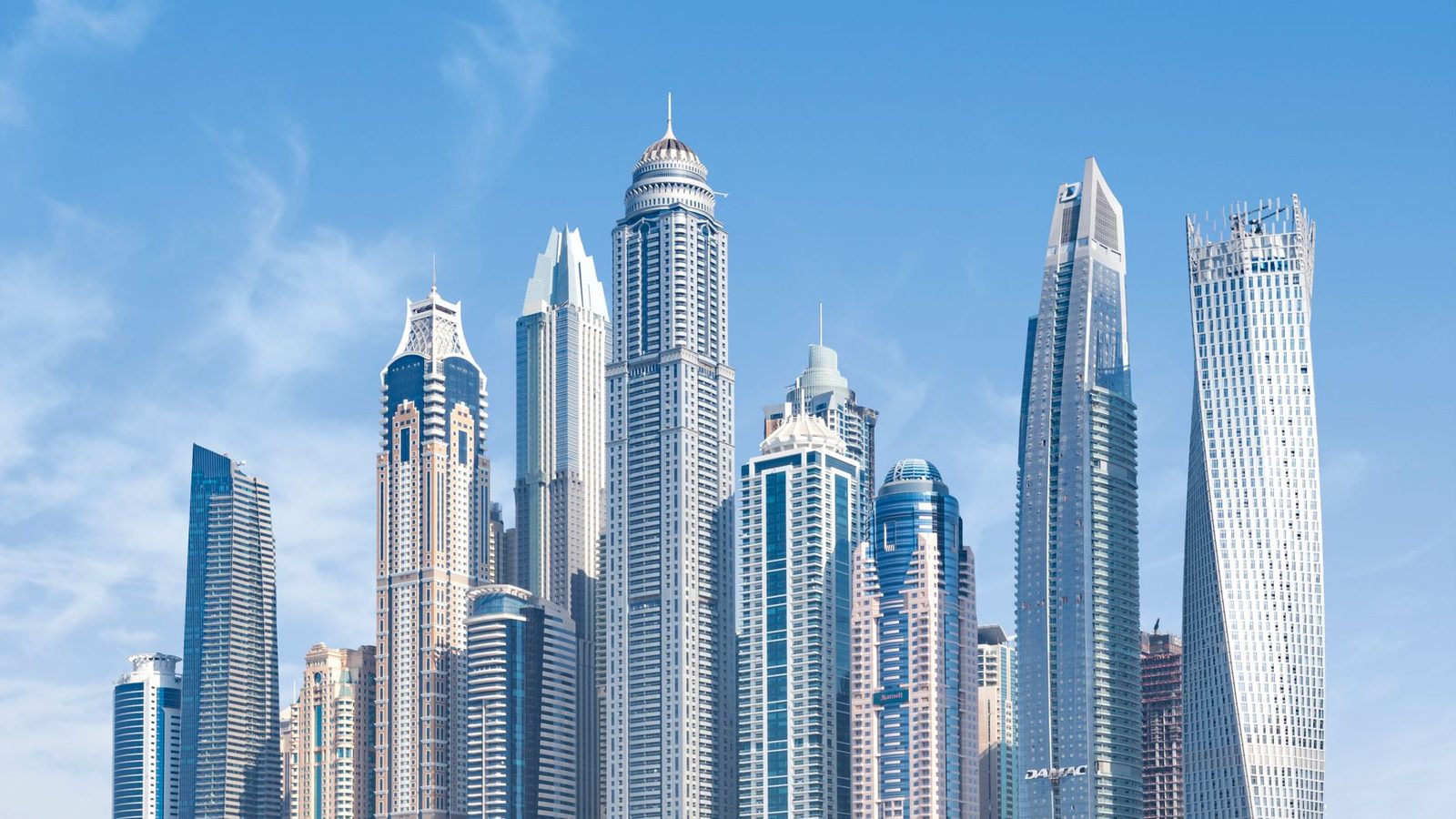 Dubai skyline under a clear blue sky, representing the UAE's regulated industries