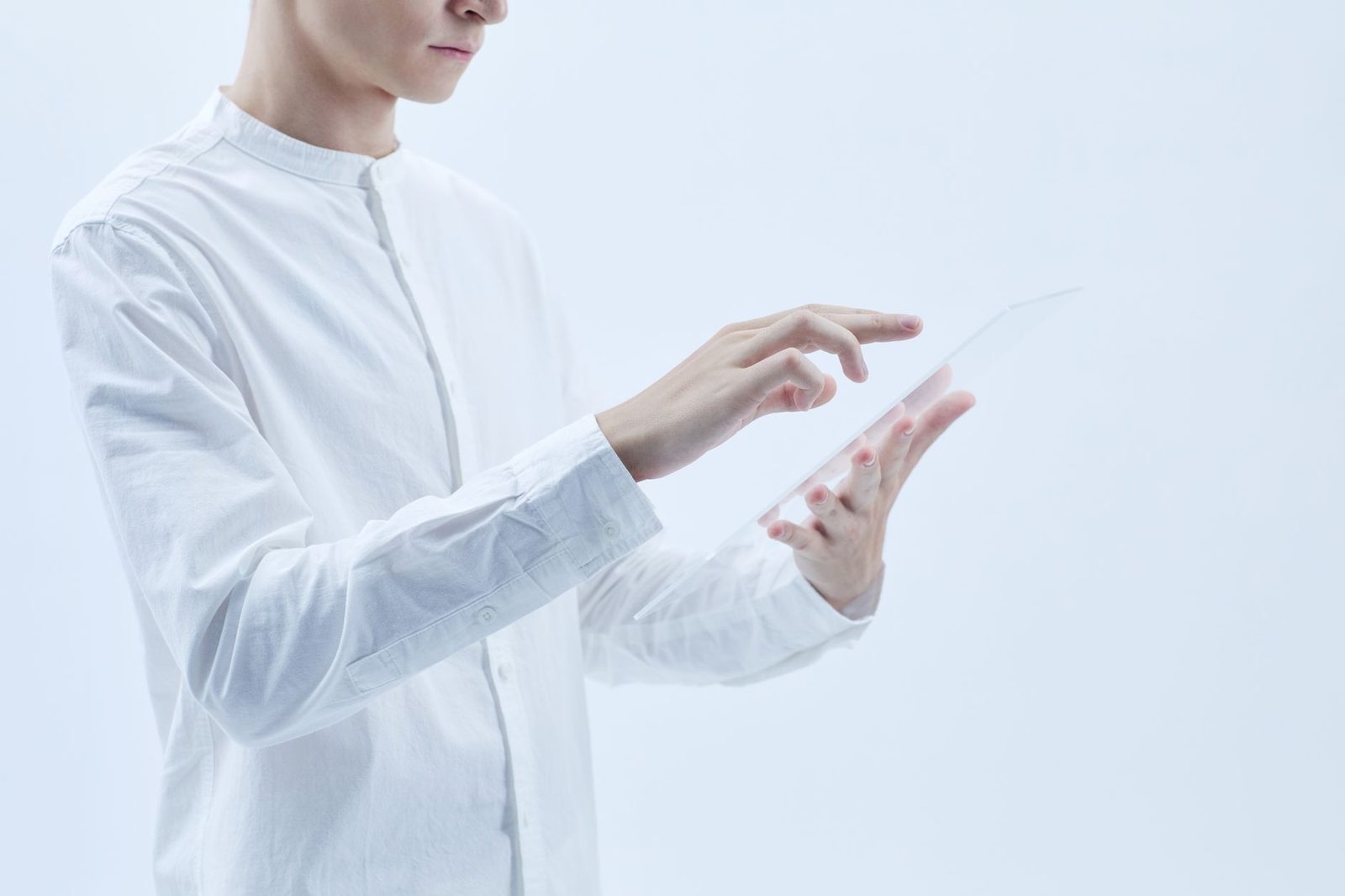 Person using a transparent tablet, representing Athena's digital transformation services